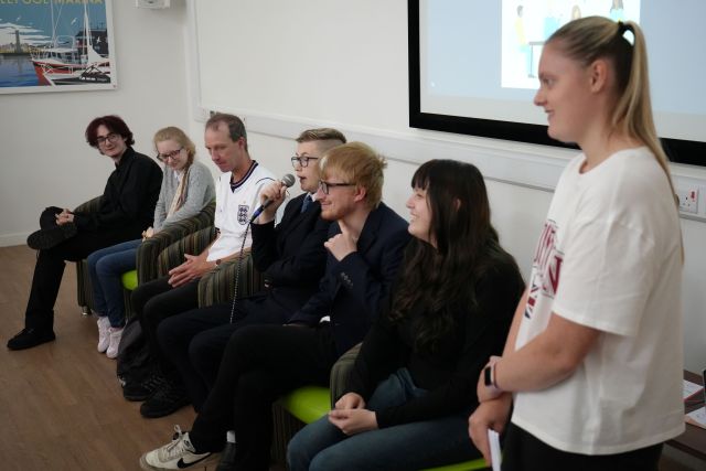 Supported interns and volunteers speaking on stage at Hartlepool's Centre for Independent Living