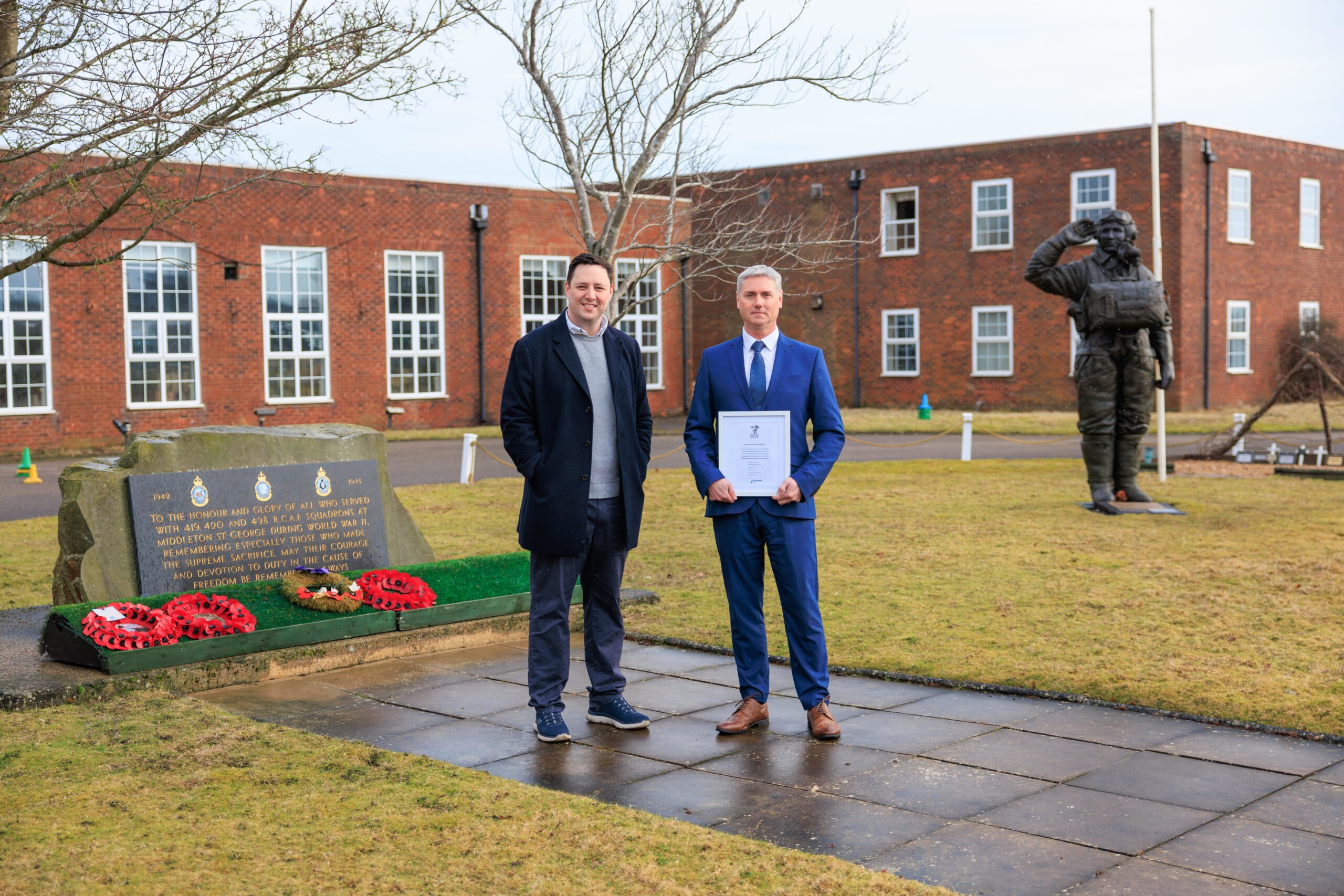 Image of Tees Valley Mayor Ben Houchen and Teesside Airport Operations Director Steve Land with the Armed Forces Covenant in hand - which was signed by the airport in 2025